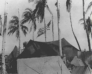 American Flag flies over beach camp on Taclaban in the Southwest Pacific in WWII - signal corps photo