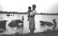 Luzon woman and child, water buffalo in river - Peno River